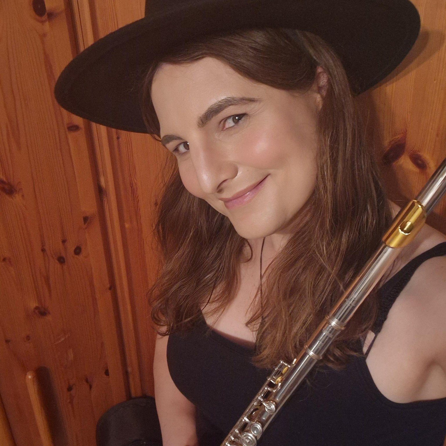 Diana S. Engelhard holding a silver concert flute.